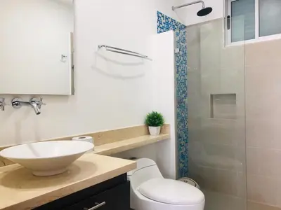 a bathroom with a toilet and a sink and a shower at Apartamentos Cartagena Oceano - Eliptic in Cartagena de Indias