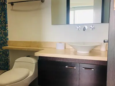 a bathroom with a sink and a toilet and a mirror at Apartamentos Cartagena Oceano - Eliptic in Cartagena de Indias