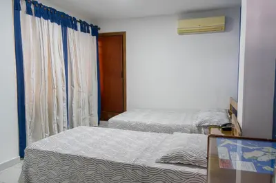 a bedroom with two beds and a window at Hotel Veleros Cartagena in Cartagena de Indias
