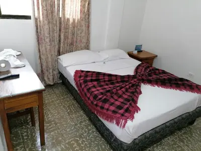 a hotel room with a bed with a scarf on it at Hotel Montecarlo Beach in Tolú