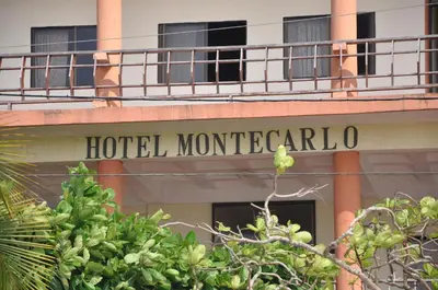 a hotel sign on the side of a building at Hotel Montecarlo Beach in Tolú