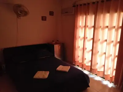 a bedroom with a black bed and a window at Comfort La Española in Cartagena de Indias