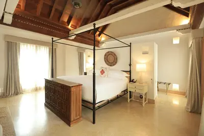 a bedroom with a canopy bed in a room at Casa Pestagua Relais Châteaux in Cartagena de Indias