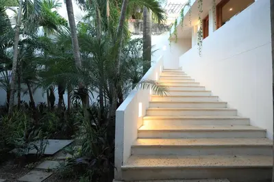 a staircase leading up to a building with palm trees at Casa Pestagua Relais Châteaux in Cartagena de Indias