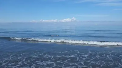 a couple of people in the water in the ocean at Special Life Beach in Tubará