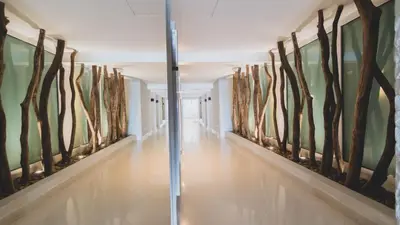 a hallway with paintings on the walls at Hotel Santa Cecilia B&B in Cartagena de Indias