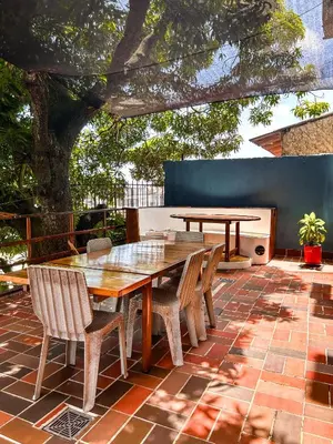 a table and chairs on a patio with a tree at La Terraza de Estella in Cartagena de Indias