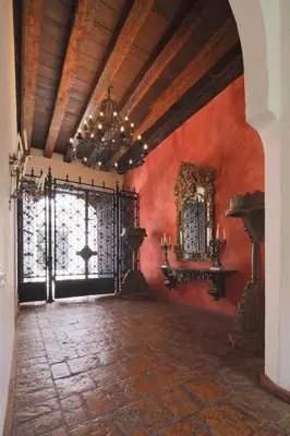 a large room with red walls and a chandelier at Hotel Boutique Casa Del Arzobispado in Cartagena de Indias