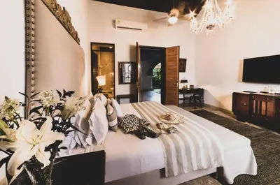 a bedroom with a white bed with flowers on it at Hotel Boutique Casa Del Arzobispado in Cartagena de Indias