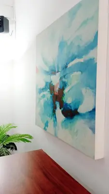a painting hanging on a white wall at Apartamento Aeromar, Santa Marta in Santa Marta