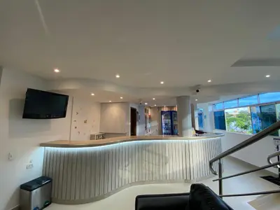 a lobby with a bar with a tv on the wall at Hotel San Sebastian Real in Cartagena de Indias