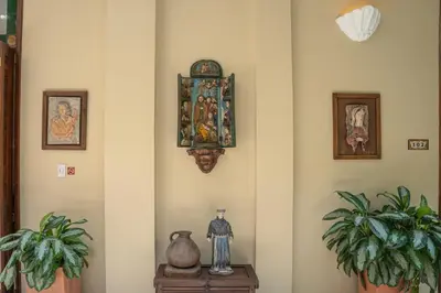a room with some plants and a clock on the wall at Hotel Casa La Fe in Cartagena de Indias
