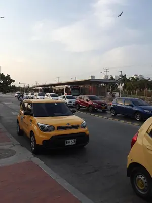 a yellow car parked on a street with other cars at Hostal Casa de Barajas in Cartagena de Indias