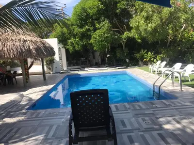 a chair sitting next to a swimming pool at Carmela Beach in Tubará