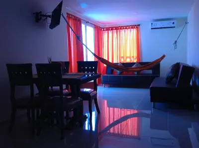 a room with a hammock and a table and chairs at Apartamentos Cartagena in Cartagena de Indias