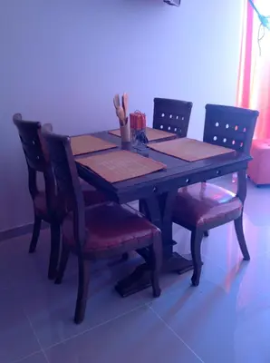 a wooden table with two chairs and a table with ahibition at Apartamentos Cartagena in Cartagena de Indias