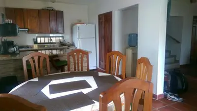 a kitchen with a table and chairs and a refrigerator at Cabaña Coveñas in Coveñas
