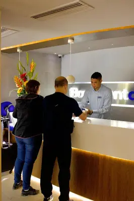a man and a woman standing at a counter at Hotel Barlovento in Cartagena de Indias