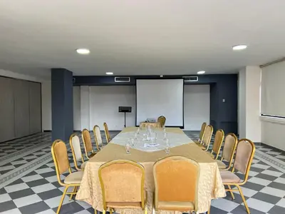 a conference room with a long table and chairs at Hotel Casa Ballesteros in Barranquilla
