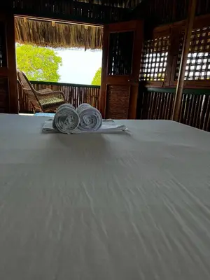 a table with two rolled towels on top of it at Hotel Puntanorte in Tintipan Island