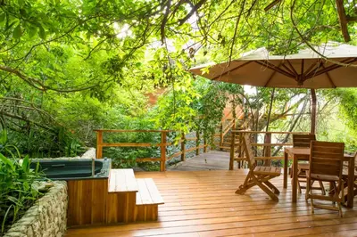 a wooden deck with chairs and an umbrella at Hotel Las Islas in Baru
