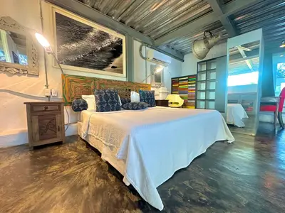 a bedroom with a bed with a white bedspread at La Passion by Masaya Collection in Cartagena de Indias