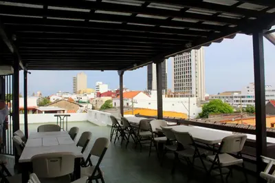 a patio with tables and chairs and a view of the city at Hotel Villa Colonial By Akel Hotels in Cartagena de Indias