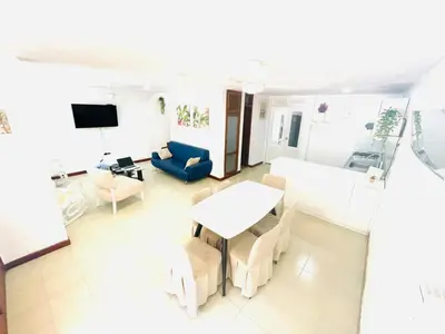 a living room with a table and chairs at Casa de playa en Bello Horizonte a una cuadra del mar in Santa Marta
