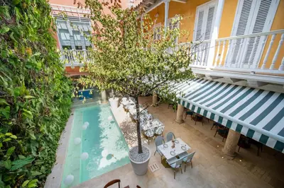 an overhead view of a pool with a tree in a courtyard at Nacar Hotel Cartagena, Curio Collection by Hilton in Cartagena de Indias
