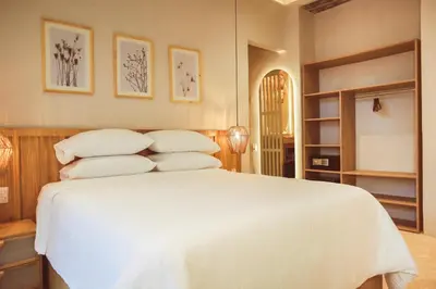 a bedroom with a bed with white sheets and pillows at Hotel Casa La Mantilla by Faranda Boutique in Cartagena de Indias