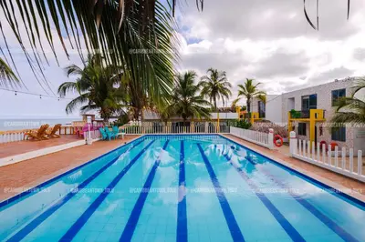 a swimming pool with a view of the ocean at Caribbean Town Tolu in Tolú