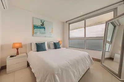 a bedroom with a bed and a large window at Palmetto Beach by MOME in Cartagena de Indias
