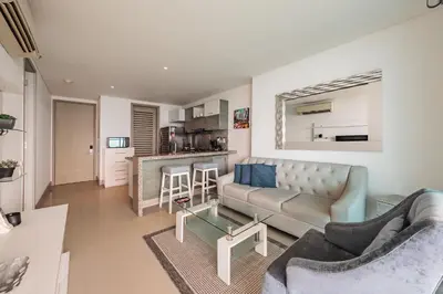 a living room with a couch and a table at Palmetto Beach by MOME in Cartagena de Indias