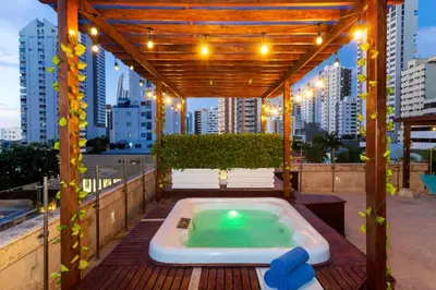 a hot tub on a deck with a pergola at GIO hotel Tama Cartagena in Cartagena de Indias