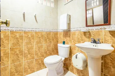 a bathroom with a toilet and a sink at Hotel Ancor in Sincelejo