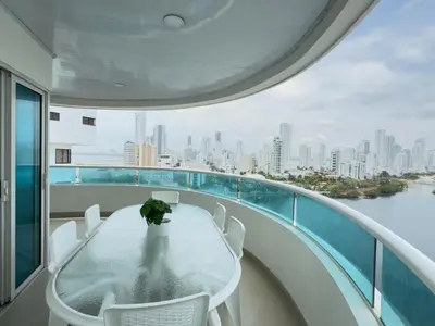 a table and chairs on a balcony with a view of the city at Apartamento semi penhouse in Cartagena de Indias