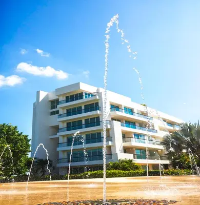 a building with a fountain in front of a building at Estelar Playa Manzanillo - All inclusive in Cartagena de Indias
