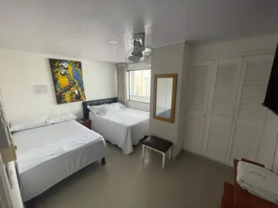 a hotel room with two beds and a mirror at Apartamento por temporadas en Bocagrande Cartagena in Cartagena de Indias