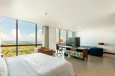 a bedroom with a bed and a desk with a television at Holiday Inn Cartagena Morros by IHG in Cartagena de Indias