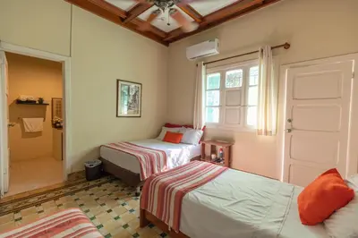 a bedroom with two beds and a window at La casa azul in Cartagena de Indias