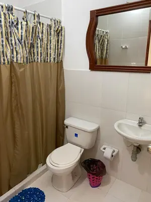 a bathroom with a toilet and a sink at Habitación I frente a la playa ( Bocagrande ) in Cartagena de Indias