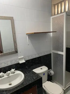 a bathroom with a sink and a toilet and a mirror at Habitación I frente a la playa ( Bocagrande ) in Cartagena de Indias