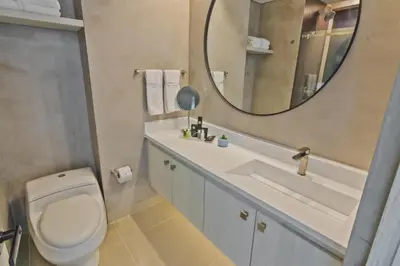 a bathroom with a toilet and a sink and a mirror at Sonesta Hotel Cartagena in Cartagena de Indias