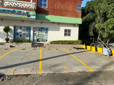 an empty parking lot in front of a building at Hotel Troncal Del Caribe in Ciénaga