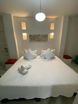 a bedroom with a white bed with towels on it at Patio de Getsemani in Cartagena de Indias