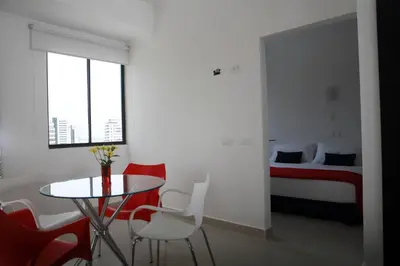 a room with a table and chairs and a bed at Zalmedina Hotel in Cartagena de Indias