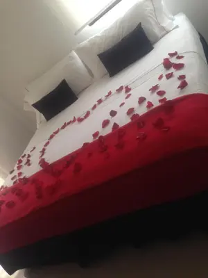 a red and white bed with flowers on it at Zalmedina Hotel in Cartagena de Indias
