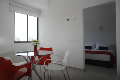 a room with a table and chairs and a bed at Zalmedina Hotel in Cartagena de Indias