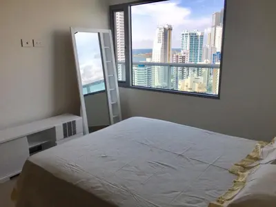 a bedroom with a bed and a large window at luxuriuso apartament in Cartagena de Indias