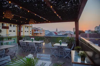 a patio with tables and chairs and a view of a city at Cartagena Royal Hotel Boutique in Cartagena de Indias
